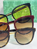 Gucci glasses assortment with gold-trim frames, including black and burgundy, yellow lenses