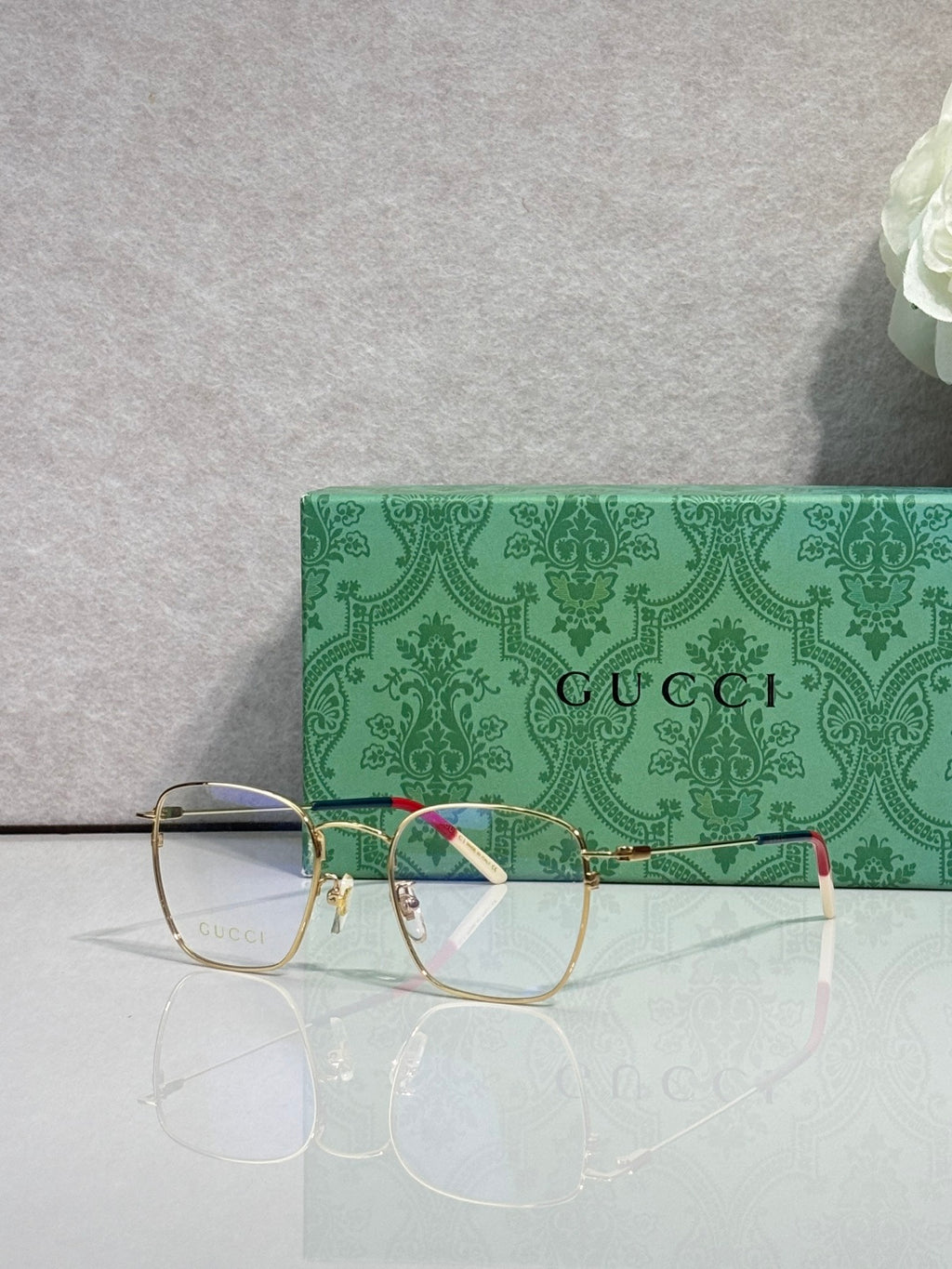 Gucci optical glasses with green frame, gold bridge, red inner stripe, clear lenses