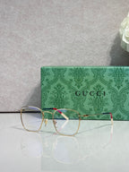 Gucci optical glasses with green frame, gold bridge, red inner stripe, clear lenses