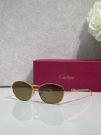 Gold-tone round glasses with green-tinted lenses and slim gold frame