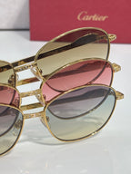 Gold-tone round glasses with pink and blue tinted lenses, stacked