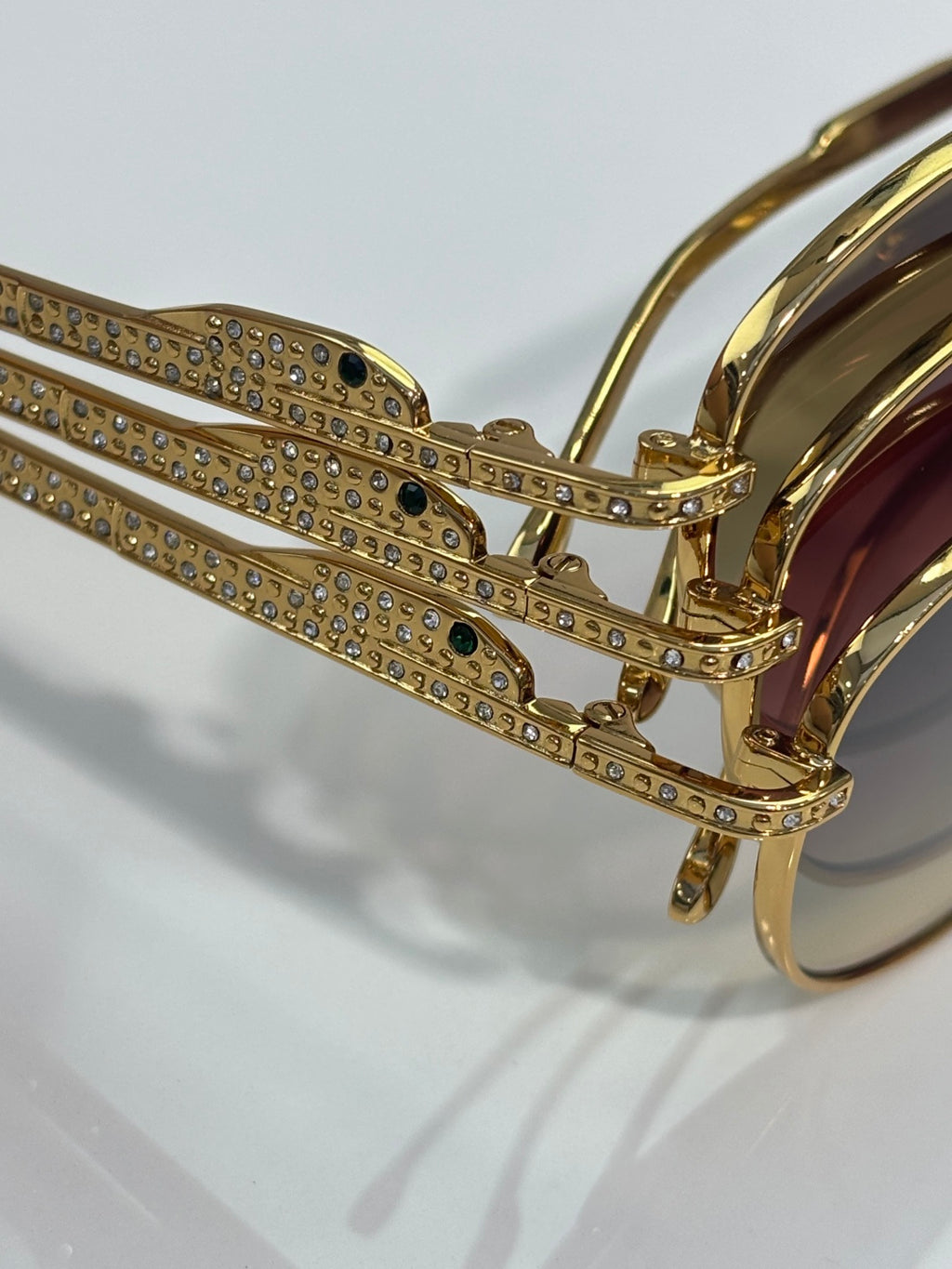 Gold-tone eyeglass temple with rhinestone strip and side hinge