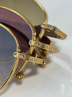 Gold-tone round glasses with rhinestone bar on the temple