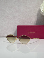 Gold-tone round sunglasses with dark lenses and rhinestone-accented arms