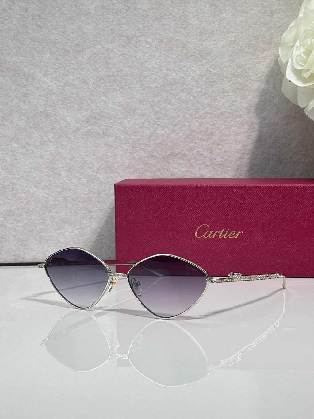 Gold-tone round sunglasses with violet-tinted lenses and slim metal frame