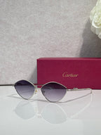 Gold-tone round sunglasses with violet-tinted lenses and slim metal frame