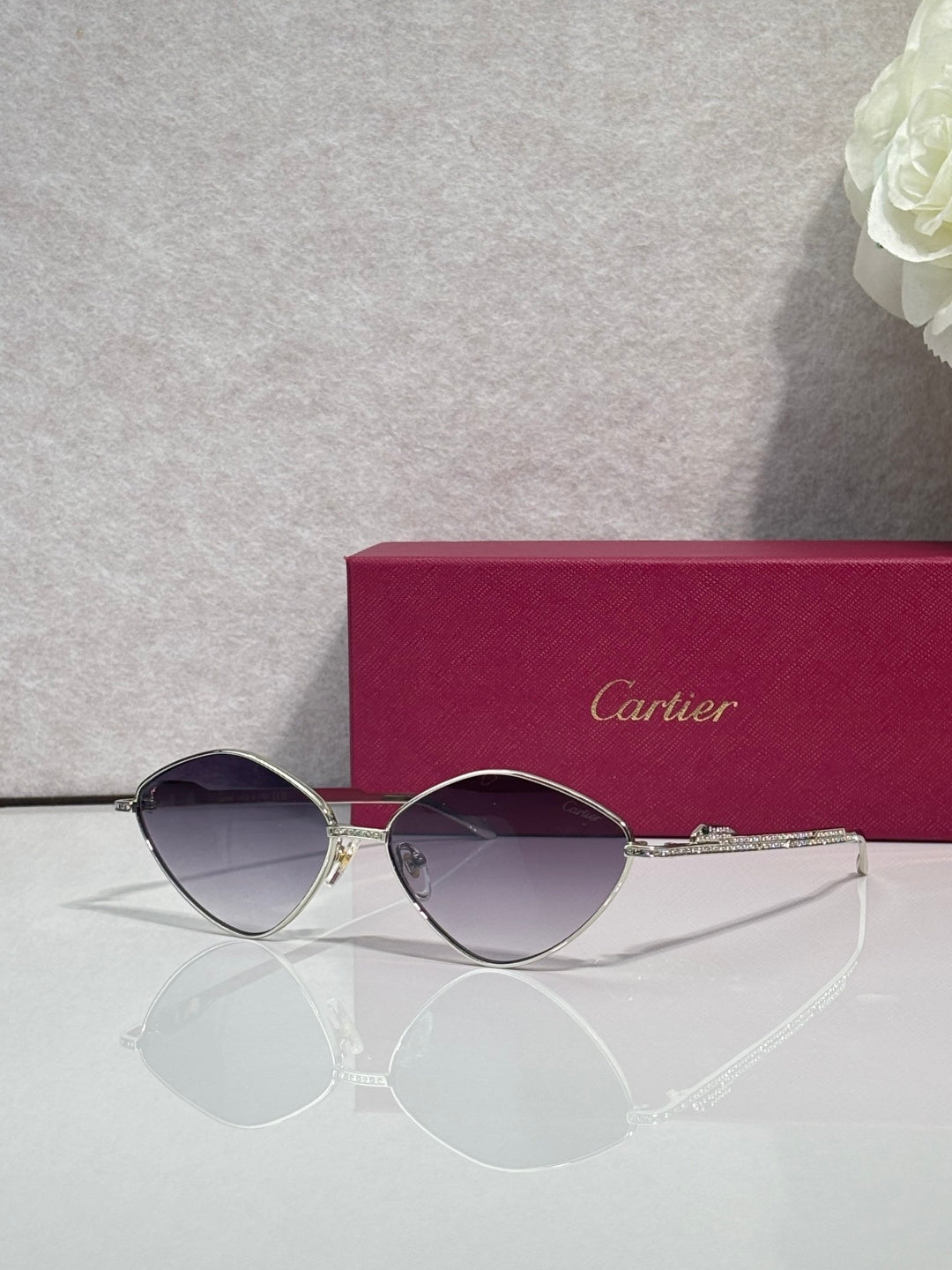 Gold-tone round sunglasses with violet-tinted lenses and slim metal frame