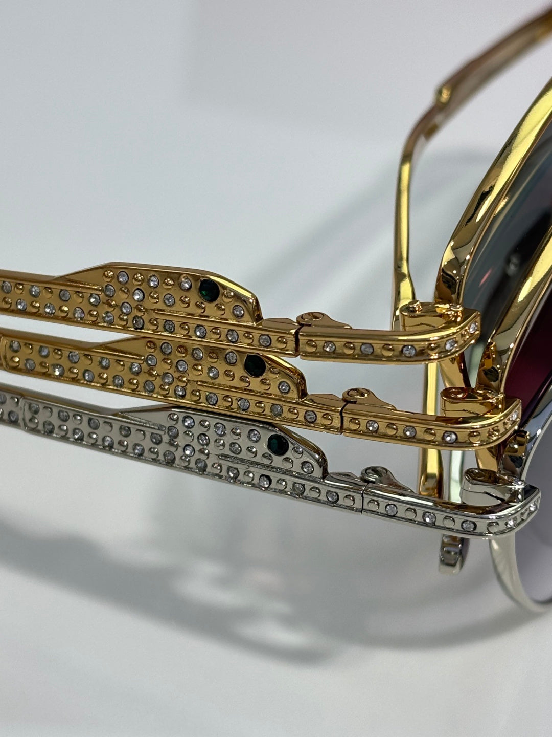 Gold-tone eyeglass frame with rhinestone-embellished temples and hinge details