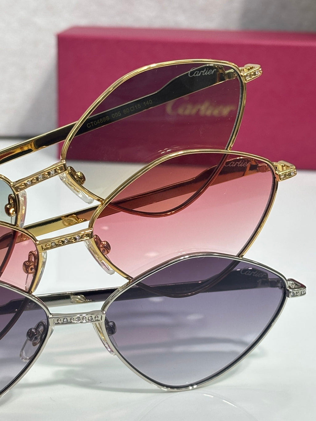 Overlapping gold-tone round sunglasses with rhinestone detailing and tinted lenses