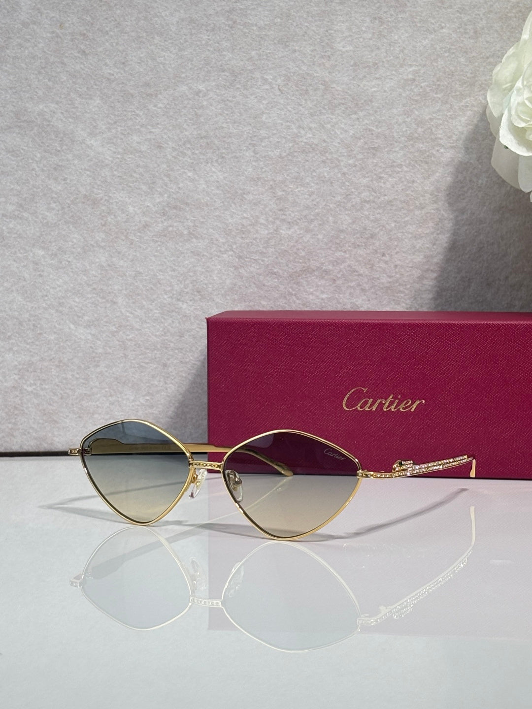 Gold-tone round sunglasses with olive-tinted lenses and thin metal frame