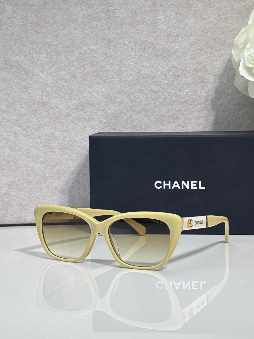 Chanel eyeglasses, light yellow square frames, clear lenses, gold logo on temple