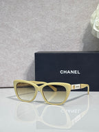Chanel eyeglasses, light yellow square frames, clear lenses, gold logo on temple
