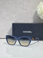 Chanel eyeglasses, blue square frames, tinted lenses, gold logo on temple