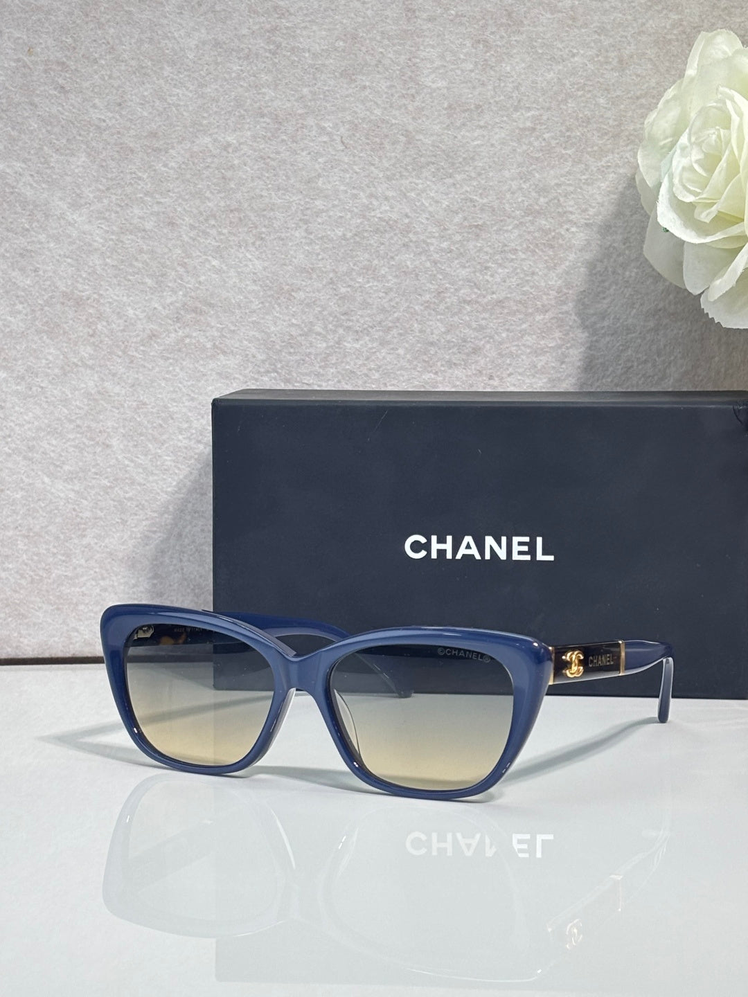 Chanel eyeglasses, blue square frames, tinted lenses, gold logo on temple