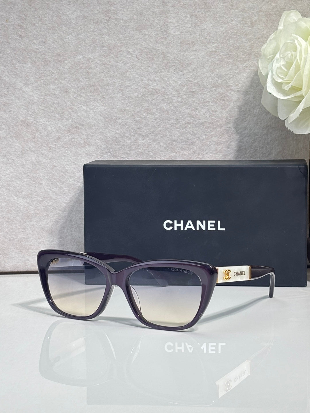 Chanel eyeglasses, dark blue square frames, clear lenses, gold logo on temple