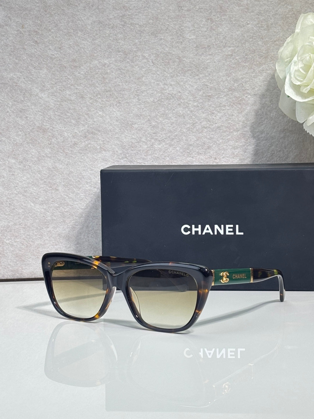Chanel eyeglasses, tortoiseshell frames, amber tinted lenses, gold logo on temple