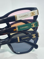 Chanel glasses close-up of temples: gold, green, and blue inlays with CHANEL text