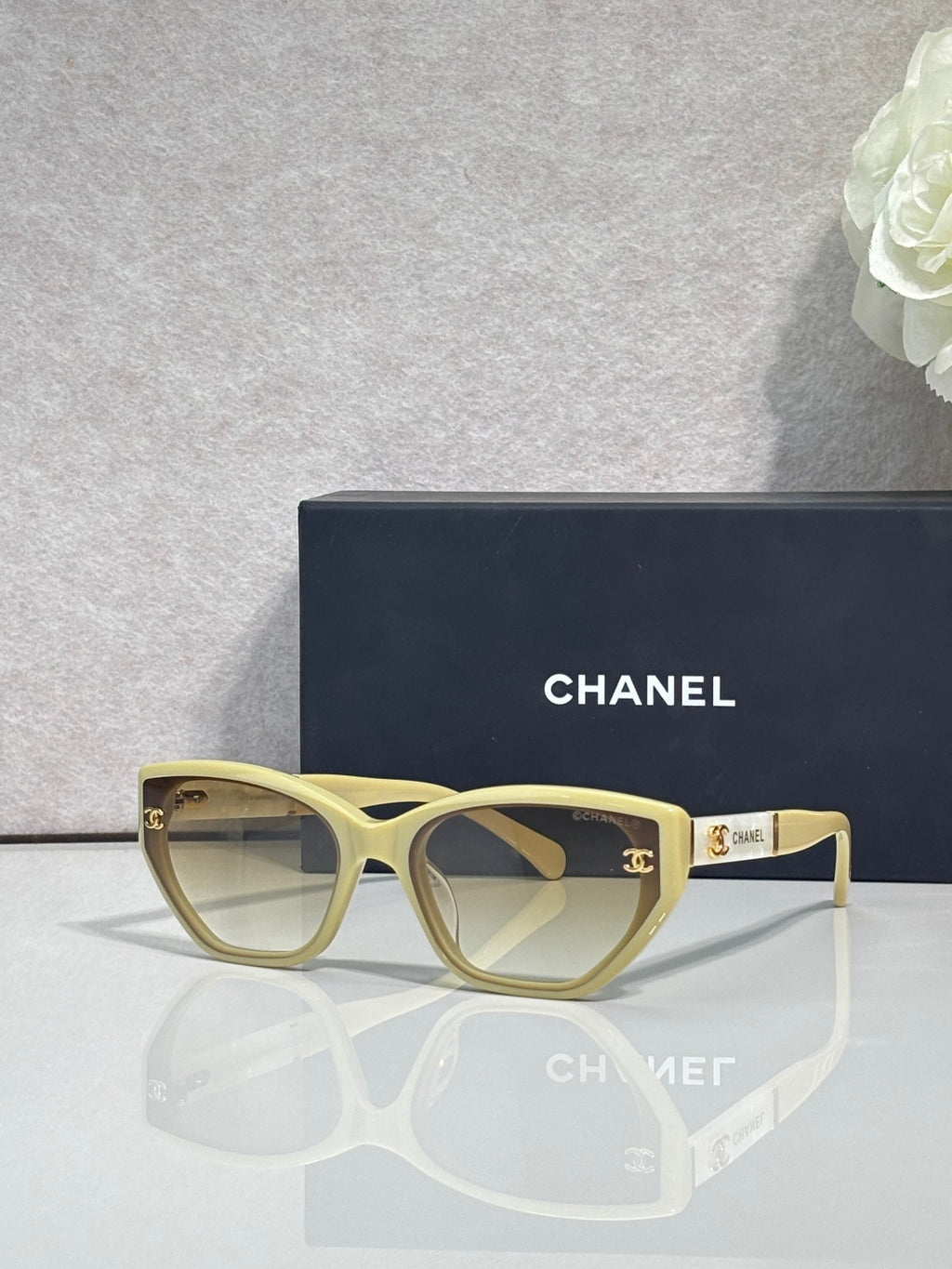 Chanel glasses with light gold frames and beige gradient lenses, gold CC accents