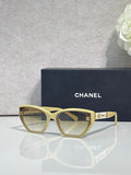 Chanel glasses with light gold frames and beige gradient lenses, gold CC accents