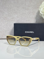 Chanel glasses with light gold frames and beige gradient lenses, gold CC accents