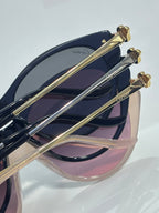 Cartier sunglasses close-up of gold-tone temples and dark tinted lenses