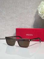 Prada eyeglasses with dark frame, dark lenses, and red temple accents