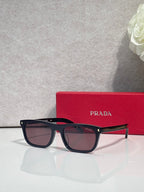 Prada eyeglasses with dark frame, brown lenses, and red temple accents