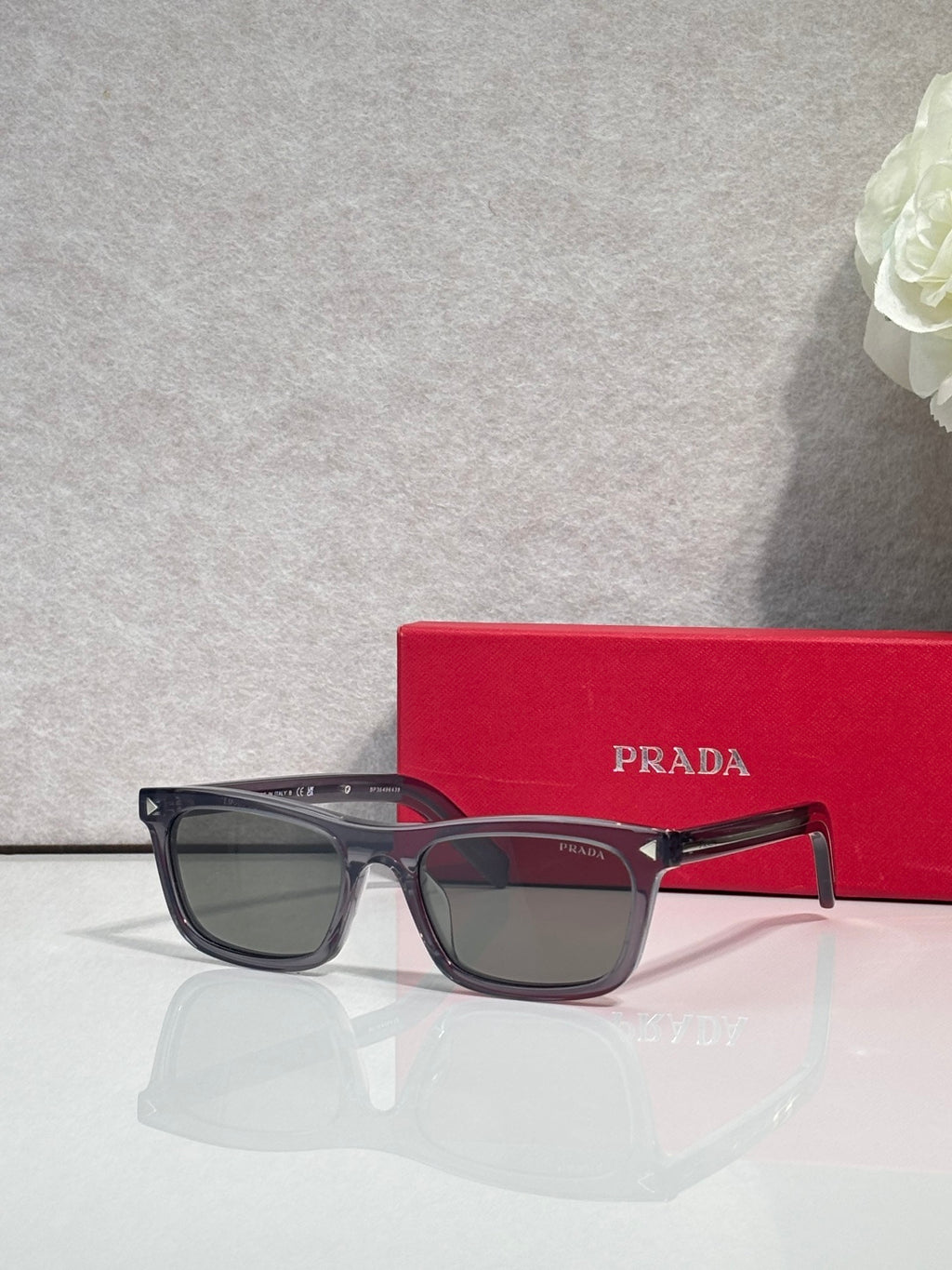 Prada sunglasses with dark frame and gray-tinted rectangular lenses
