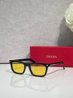 Prada sunglasses with black frame and yellow-tinted rectangular lenses