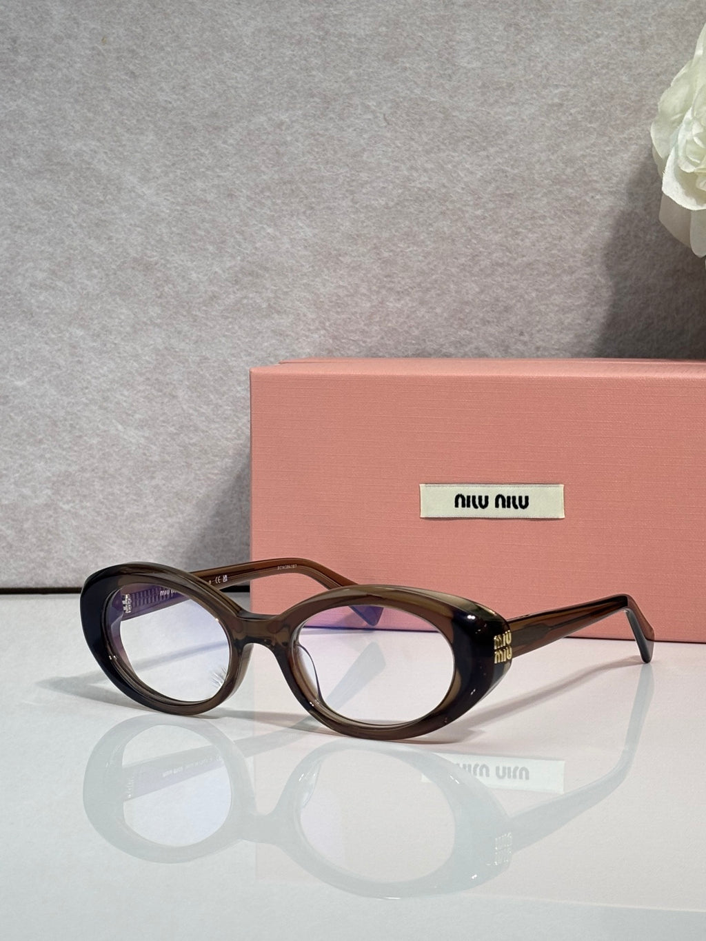 Miu Miu eyeglasses, dark tortoiseshell oval frames, logo on temple