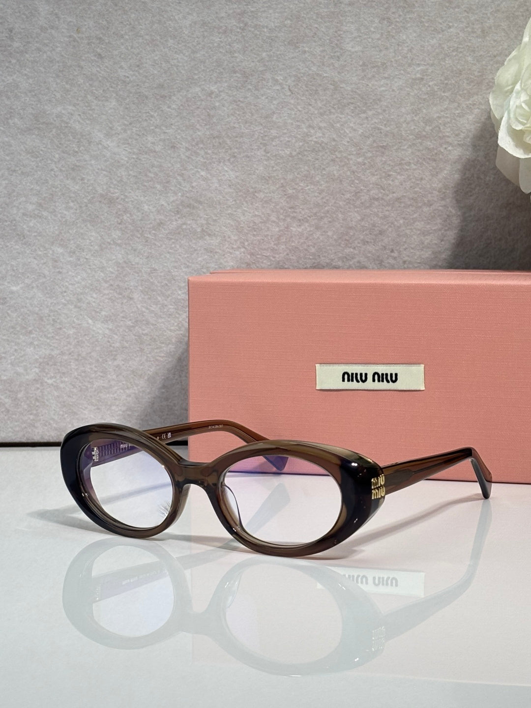 Miu Miu eyeglasses, dark tortoiseshell oval frames, logo on temple