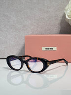 Miu Miu eyeglasses, black tortoiseshell oval frames, gold logo detail