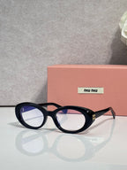 Miu Miu eyeglasses, dark tortoiseshell oval frames, logo plate on temple