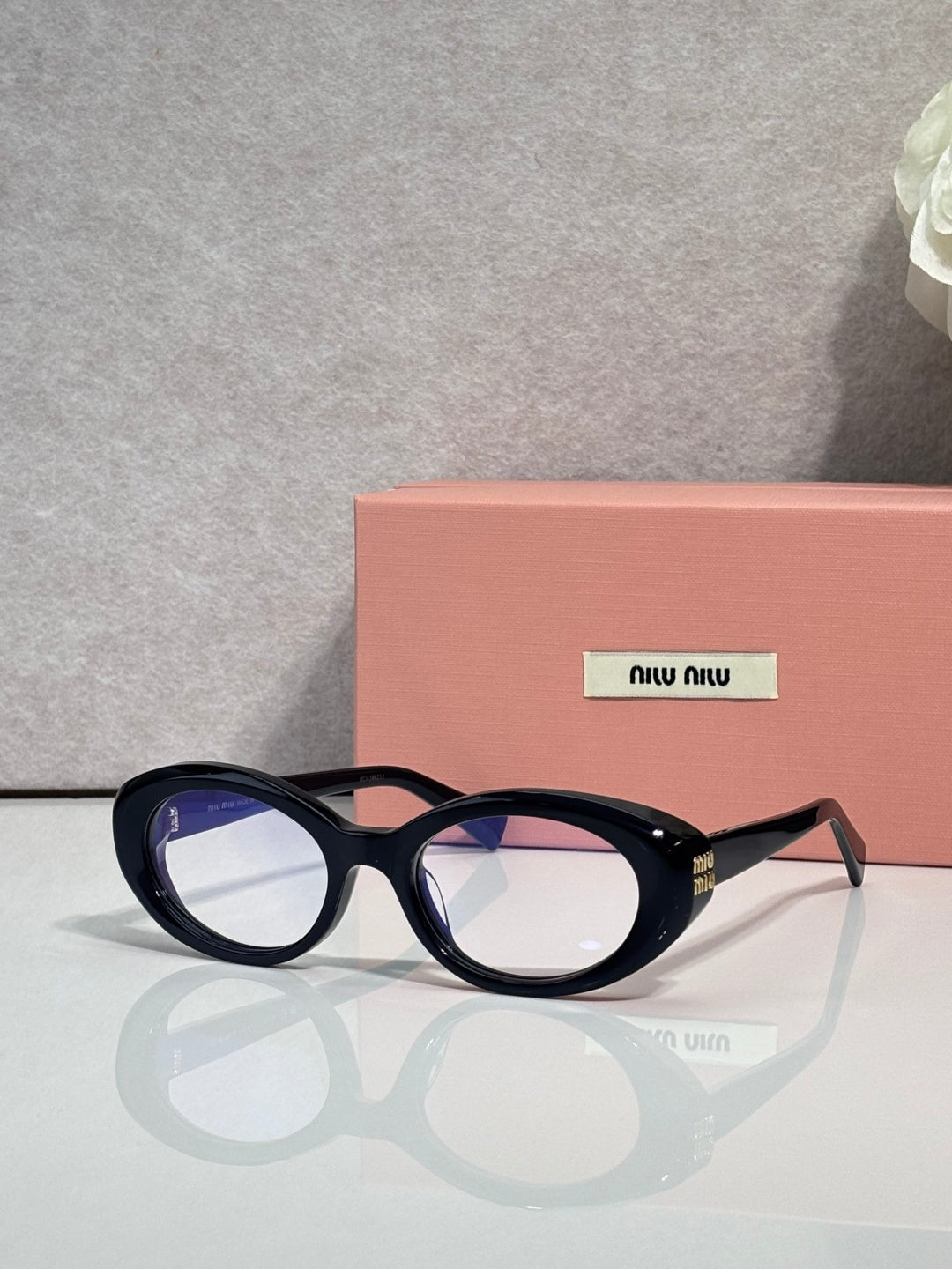 Miu Miu eyeglasses, dark tortoiseshell oval frames, logo plate on temple