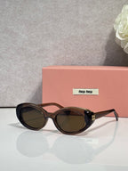 MiuMiu oval sunglasses with dark tortoise frames and dark tinted lenses