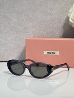 MiuMiu oval sunglasses with dark tortoise frames and black tinted lenses