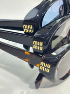 Miu Miu black sunglasses with tortoiseshell temple tips and Miu Miu logo text