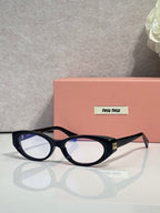 MiuMiu eyeglasses with dark glossy frames, round rectangular profile and clear front lenses