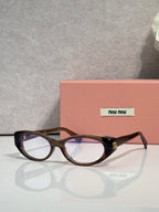 MiuMiu eyeglasses with dark tortoiseshell frames and clear lenses, logo temple detail