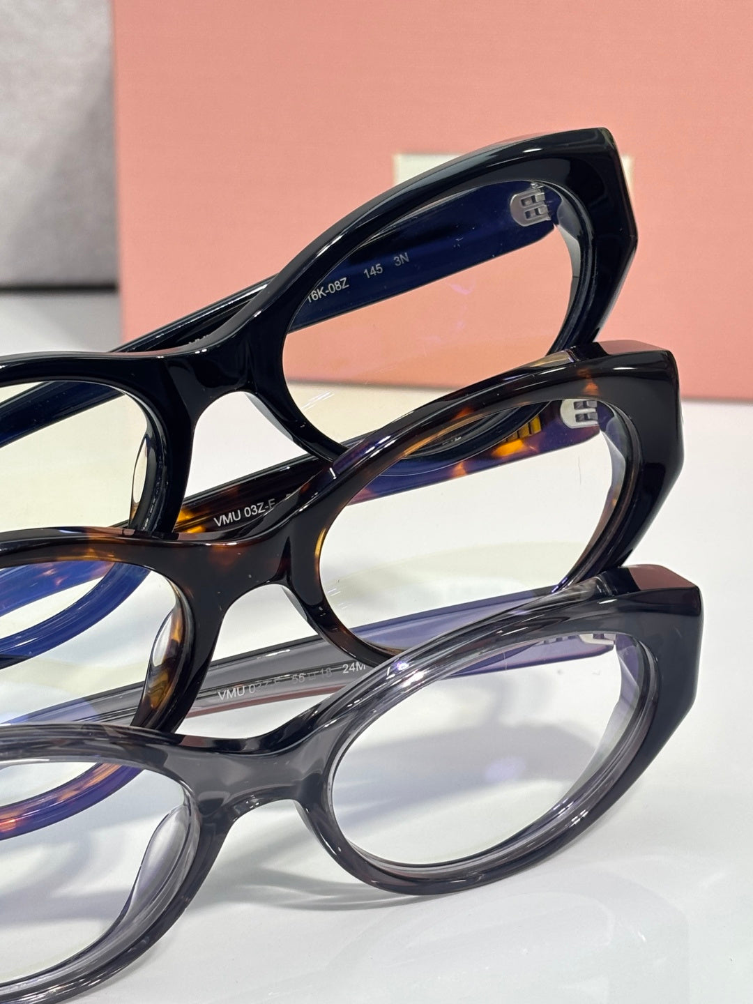MiuMiu eyeglasses close-up of dark frame and temples, showing interior logo