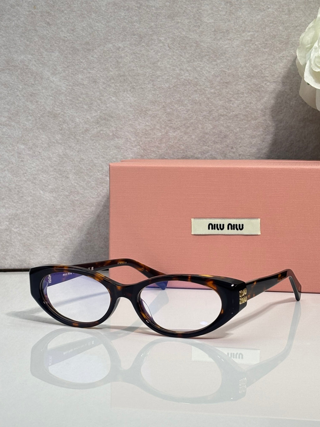 MiuMiu eyeglasses, dark tortoiseshell frame with rectangular round shape and logo arms