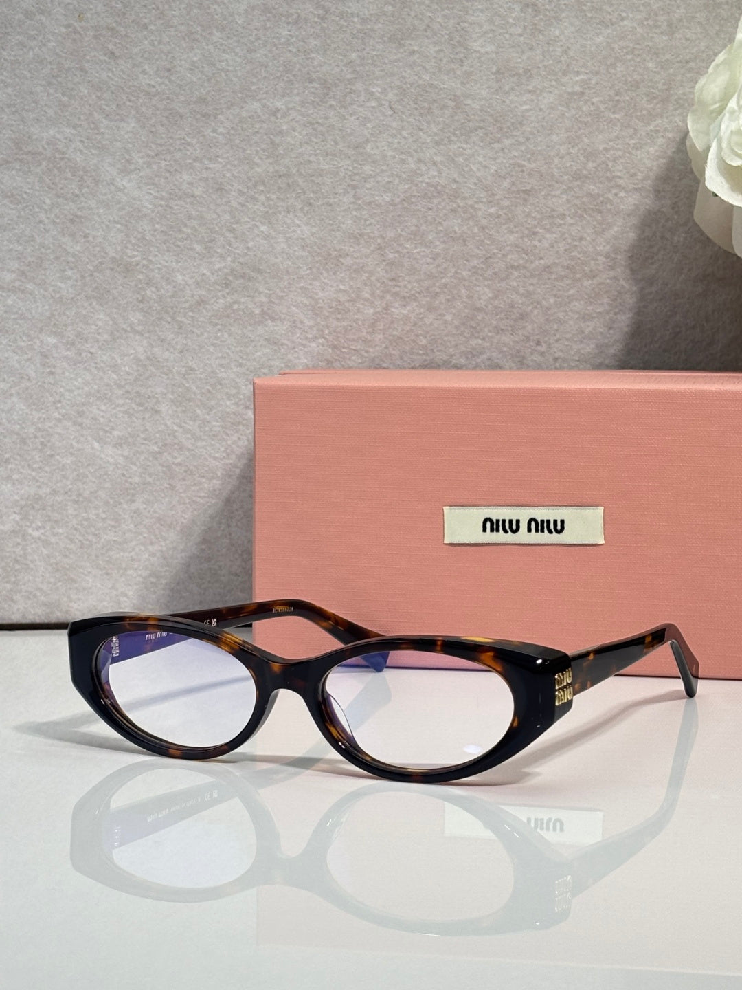 MiuMiu eyeglasses, dark tortoiseshell frame with rectangular round shape and logo arms