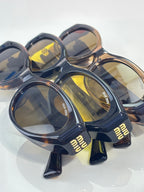 Navy sunglasses with yellow lenses and 'miu miu' temple branding