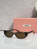 Brown cat-eye sunglasses with dark lenses and gold logo hardware