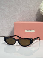 MiuMiu cat-eye sunglasses with dark lenses and black acetate frames