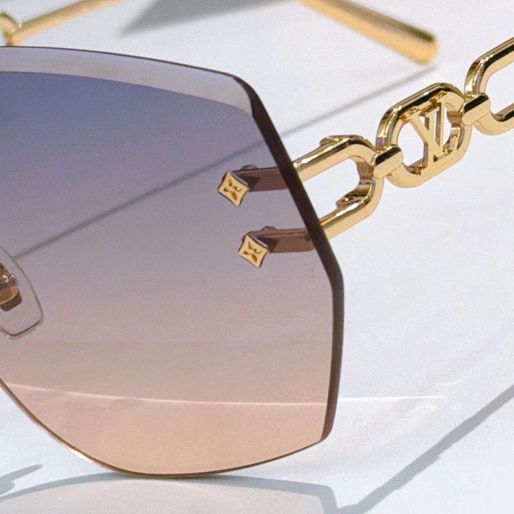 Louis Vuitton sunglasses close-up with dark lenses and gold chain temple detail
