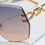 Louis Vuitton sunglasses close-up with dark lenses and gold chain temple detail