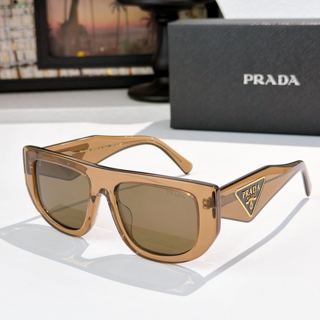 Prada sunglasses with tan frames and olive tinted lenses, triangular logo on temple.