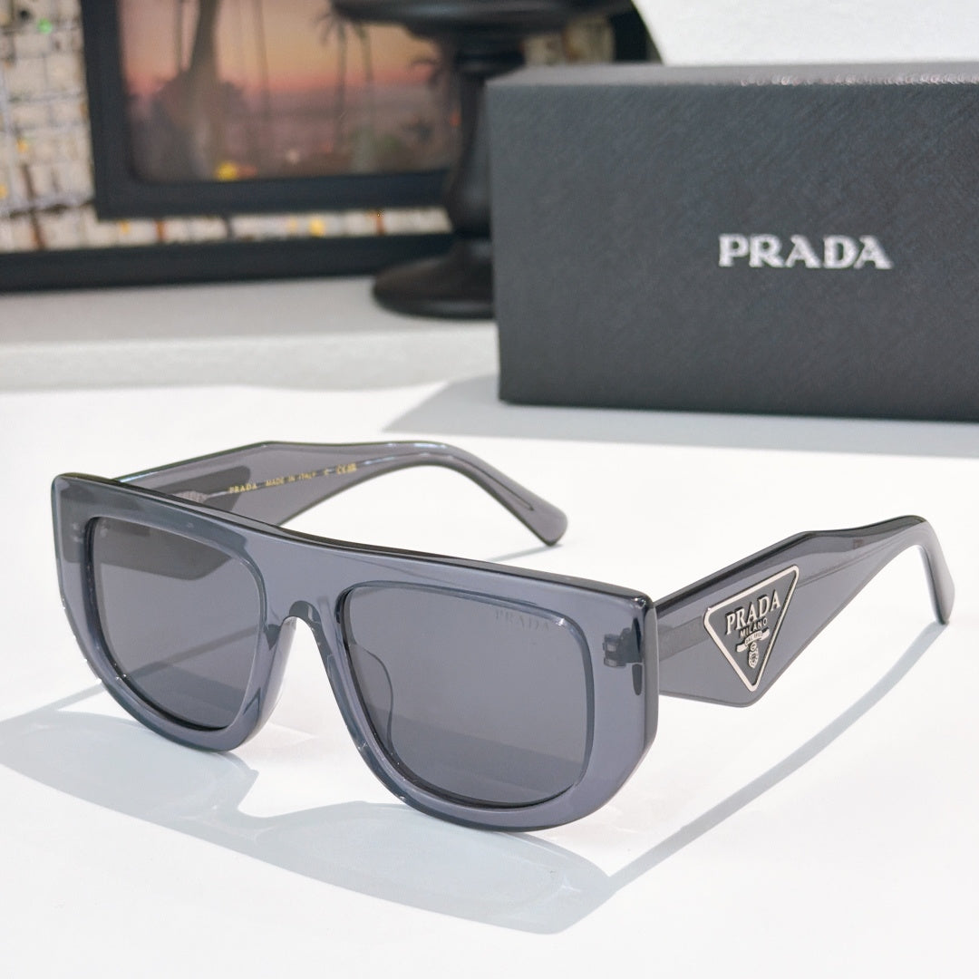 Prada sunglasses with dark gray frames and tinted lenses, triangular logo on temple.