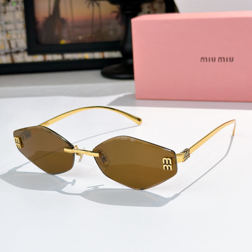 MiuMiu cat-eye sunglasses with gold frame and dark gray gradient lenses